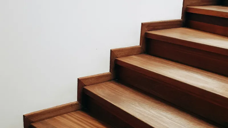 Bare timber stairs before a runner is fitted