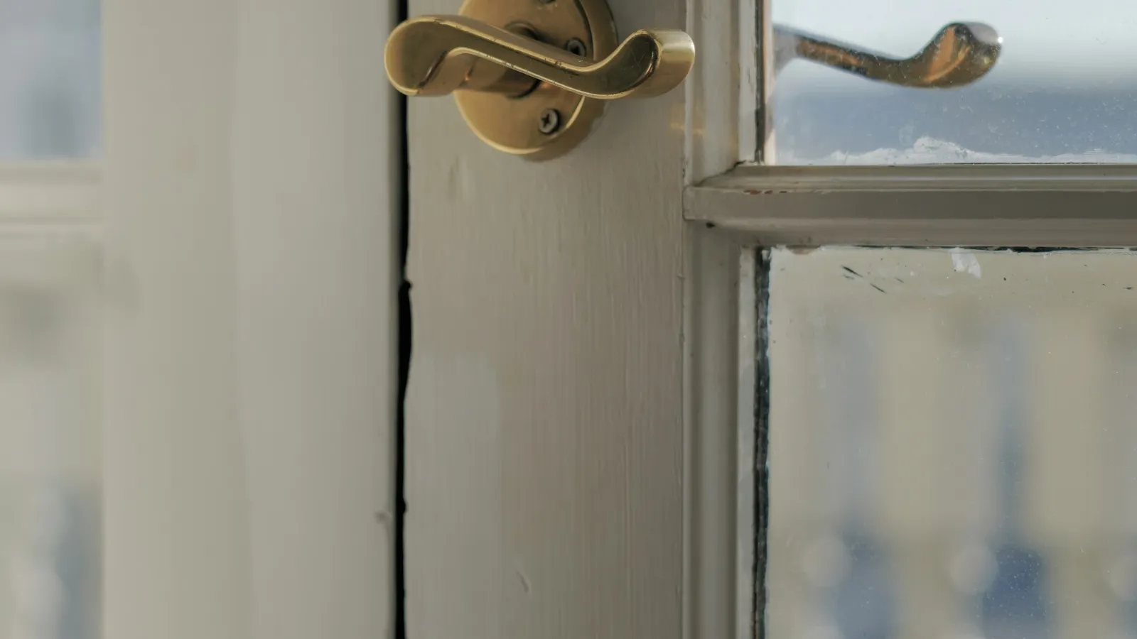 Brass latch on a painted door