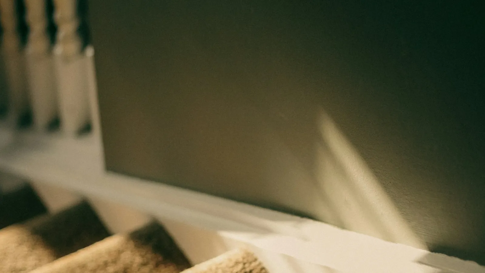 Close-up of a carpeted stair nosing in soft light
