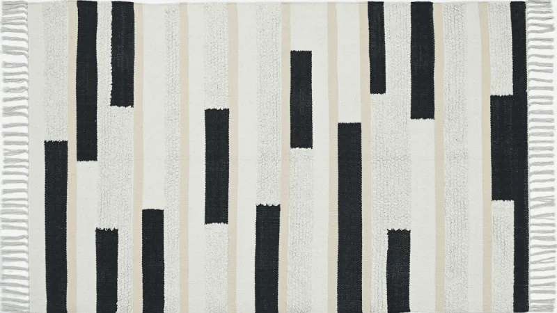Cream rug with black graphic marks
