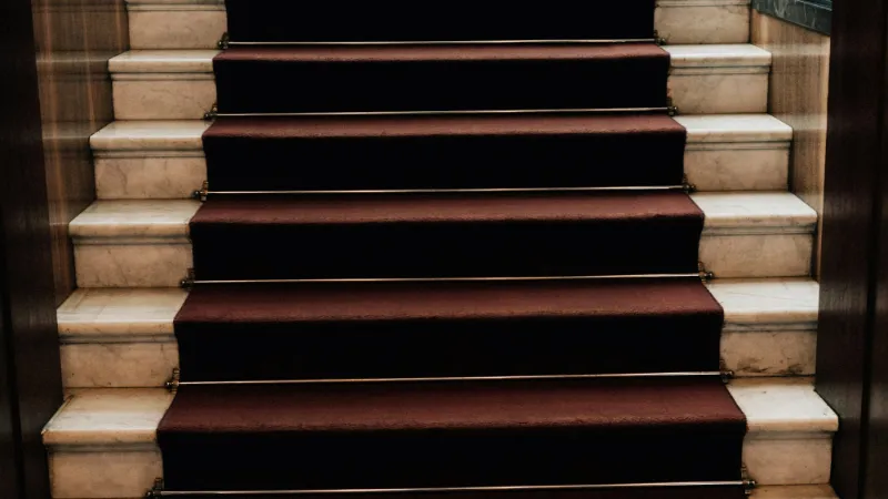 Dark red carpet on a straight flight of stairs