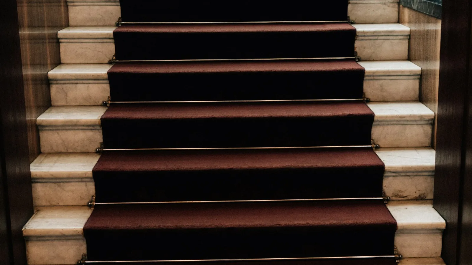 Dark red carpet on a straight flight of stairs