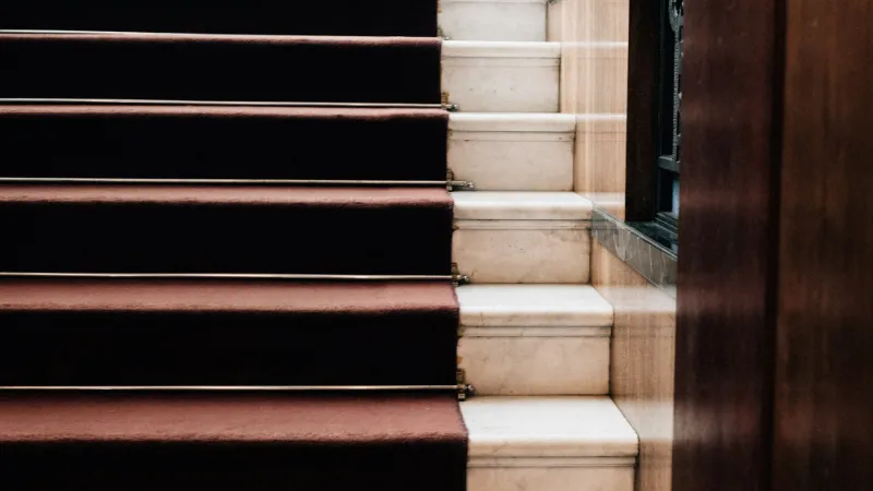 Dark red runner on pale stone steps