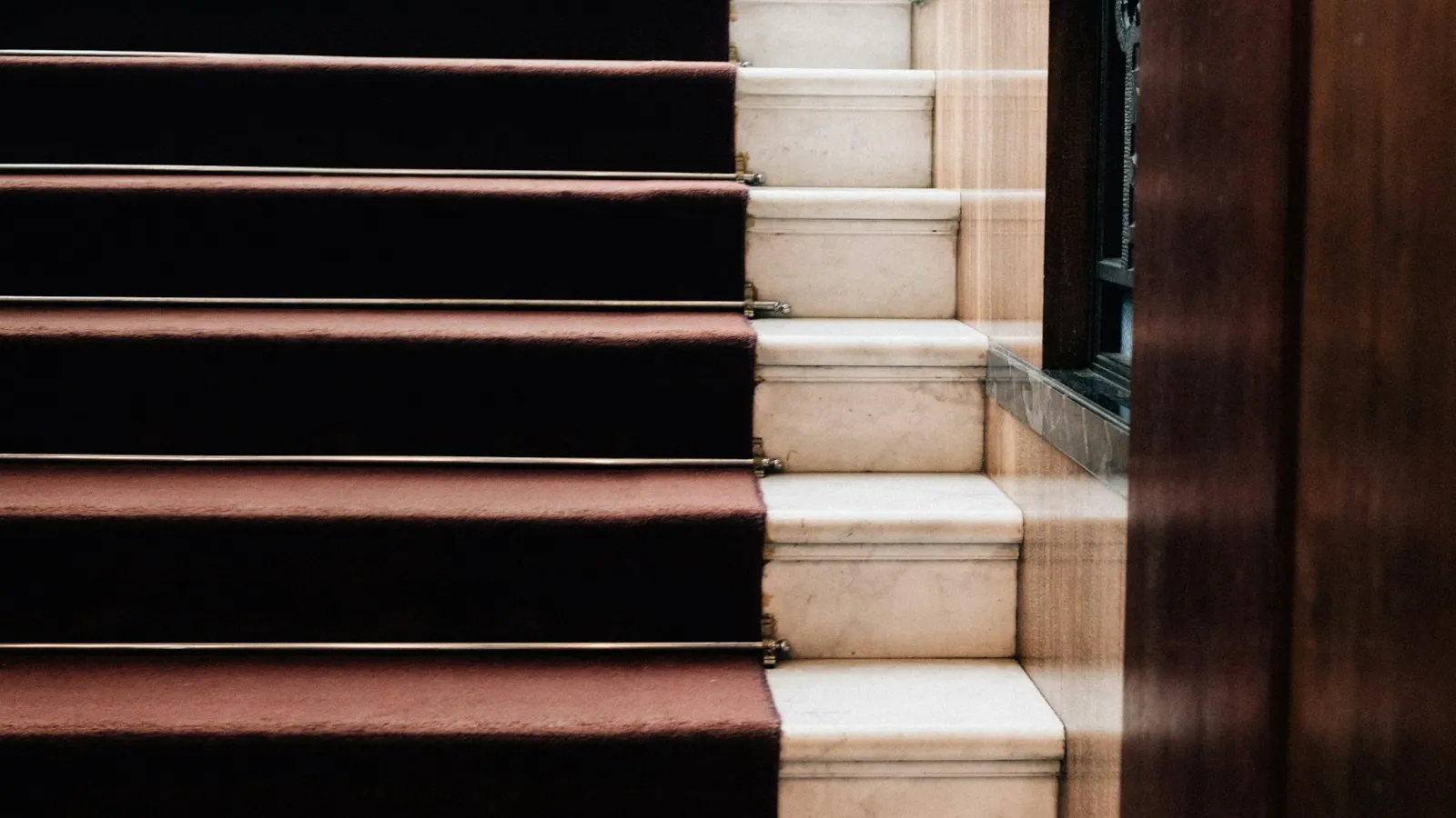 Dark red runner on pale stone steps