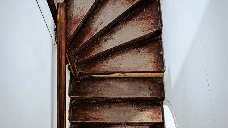 Dark timber winder steps in a tight turn