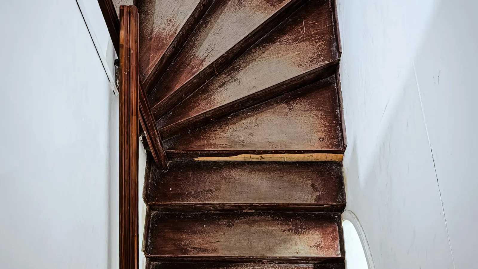 Dark timber winder steps in a tight turn
