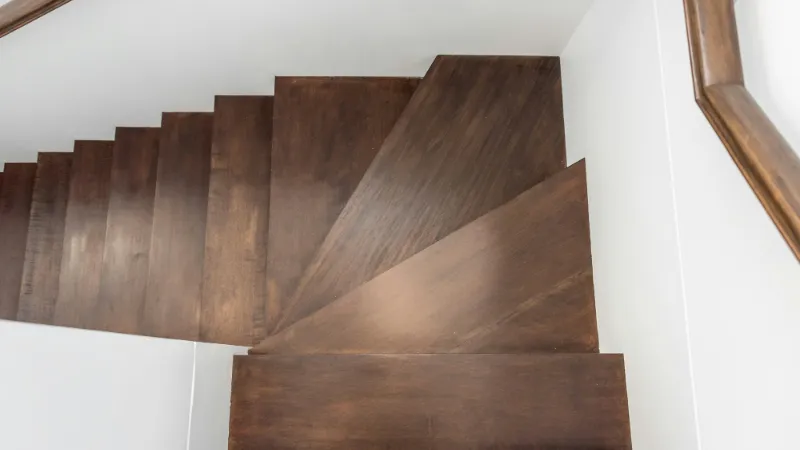 Dark timber winder steps turning a corner