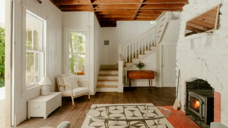 Farmhouse-style hallway with a staircase and patterned rug