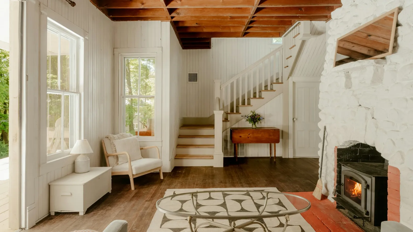Farmhouse-style hallway with a staircase and patterned rug