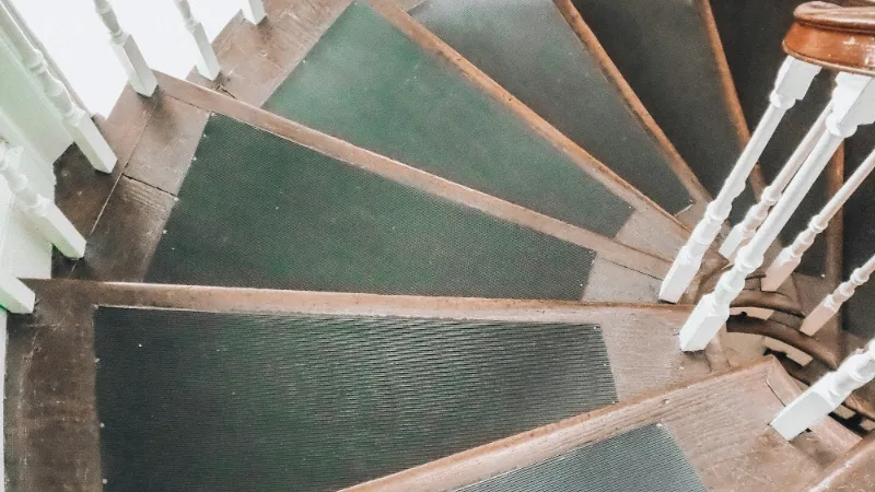 Green carpeted steps on a turning staircase
