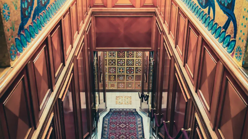 Patterned runner in a timber-panelled stairwell
