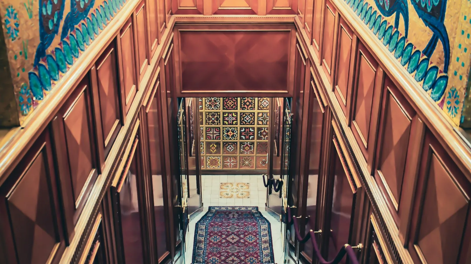 Patterned runner in a timber-panelled stairwell