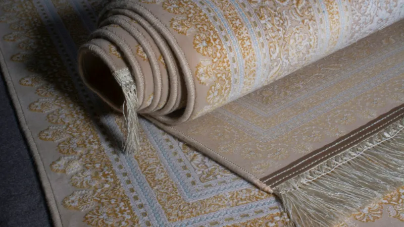 Rolled patterned rug ready to be laid