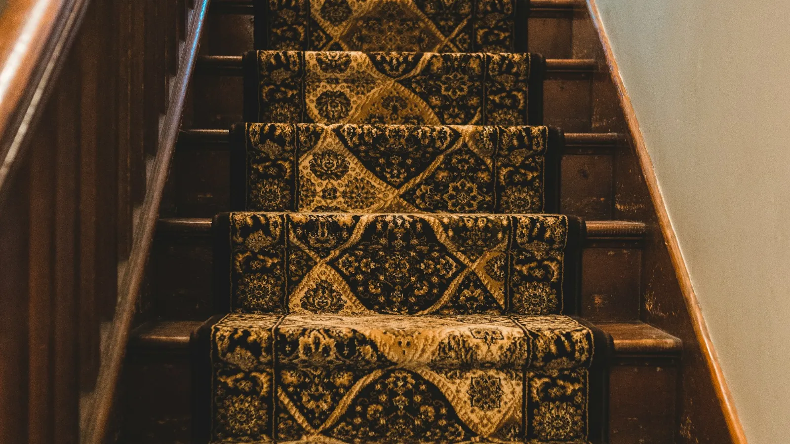 Traditional patterned runner fitted over timber stairs