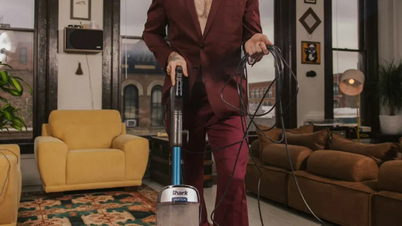Upright vacuum cleaner in use in a living room