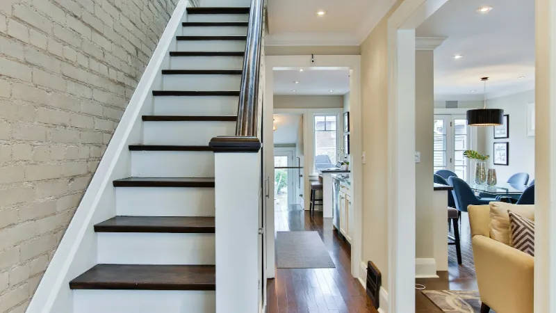 White staircase with dark treads seen from the hall
