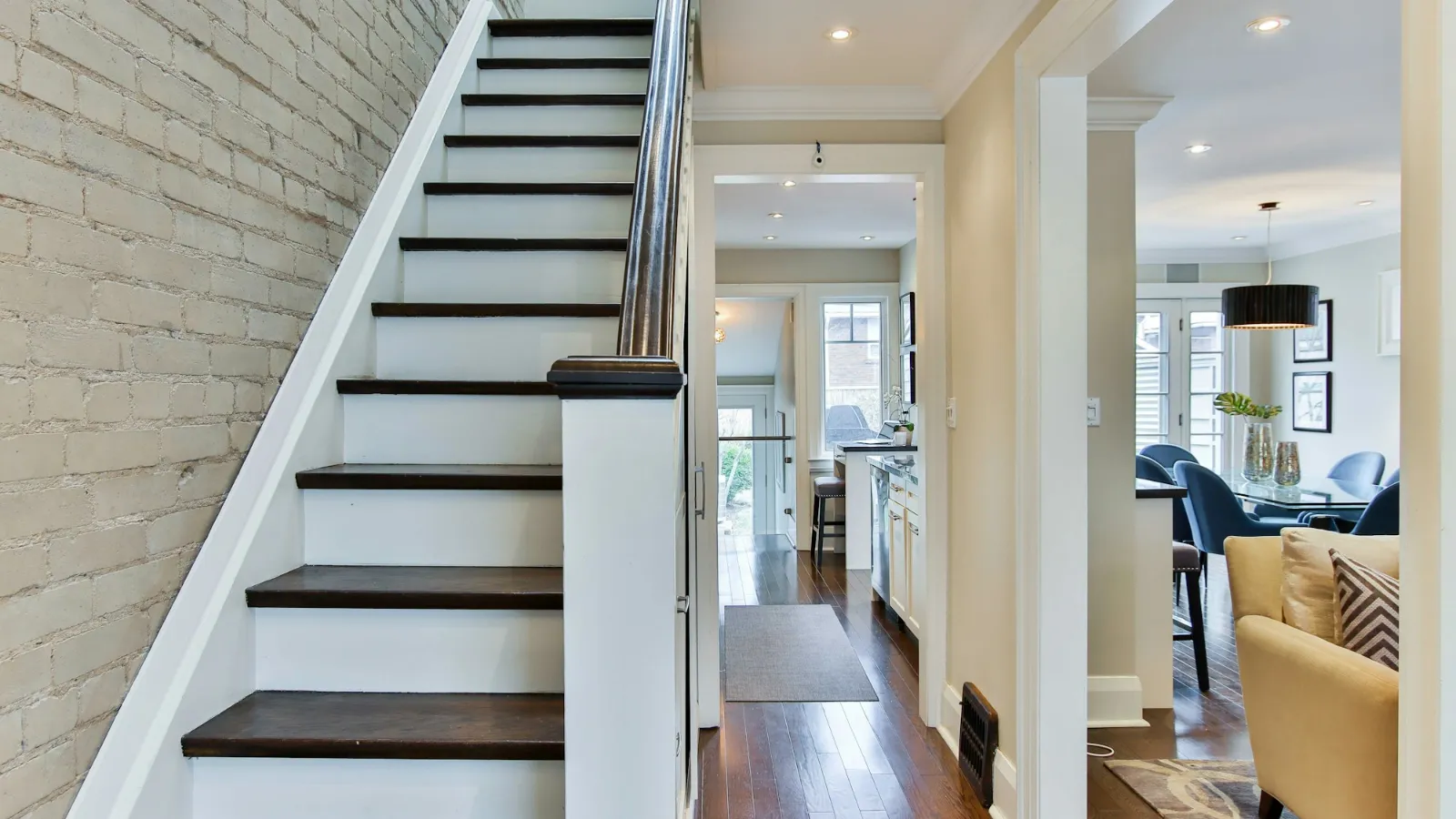 White staircase with dark treads seen from the hall